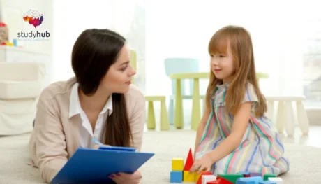 Child psychologist observing a young girl playing with blocks for Diploma in Child Psychology and Child Care QLS Level 7