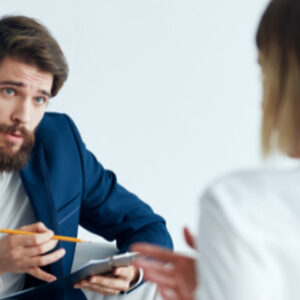 Professional recruiter interviewing a job candidate during a one-to-one meeting in a modern office.