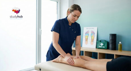 Professional therapist performing a sports massage on a client’s leg in a modern physiotherapy treatment room.