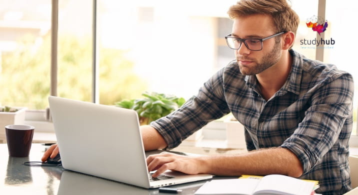 A conceptual image of a person sitting in a defensive position with a hand extended forward in a "stop" gesture against a neutral grey background.