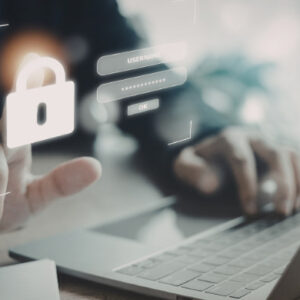 Person using a laptop with a digital security lock icon and login interface, representing cybersecurity and data protection.