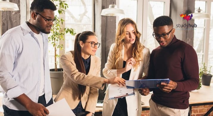 A person sitting on the floor in a defensive posture with an open palm extended forward to signal "stop," representing domestic violence awareness and prevention.
