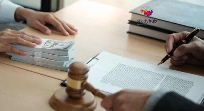 Close-up of a contract signing process with a gavel and money on a desk.