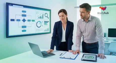 Two business professionals analyzing workflow charts and data analytics on a digital screen in a modern office.