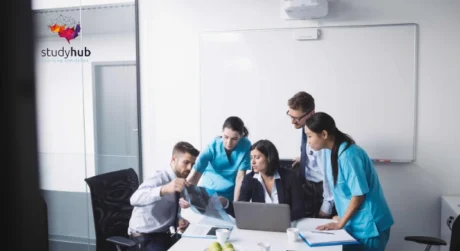 Healthcare professionals and administrators reviewing medical records and scans in a collaborative meeting, representing the Consent Training in Healthcare Course