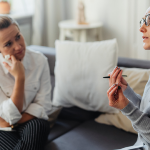 Therapist counseling a client during a one-on-one session in a calm and professional office setting.