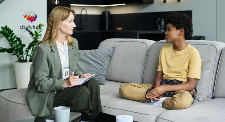 Child talking to a female therapist during a counseling session on a sofa in a modern home setting