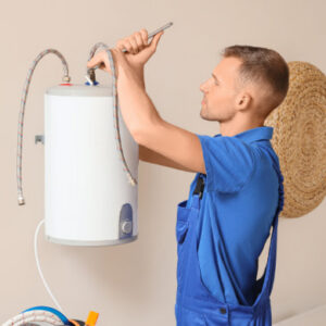 Plumber installing or repairing a wall-mounted water heater using tools in a modern home