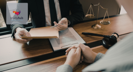 Lawyer handing over legal documents to a client across a desk with gavel and scales of justice